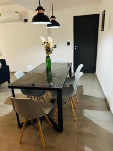 een eettafel met een vaas met bloemen erin bij Luxury Apartment Posadas 2 in Posadas