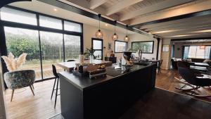 a kitchen with a large island in a living room at Maison d'architecte de la Parée in Saint-Jean-de-Monts