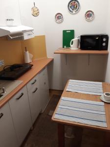 a kitchen with a table and plates on the wall at Appartment Bawaria in Cieszyn