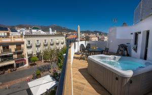 a hot tub on the balcony of a building at Apartamentos Kronox in Nerja