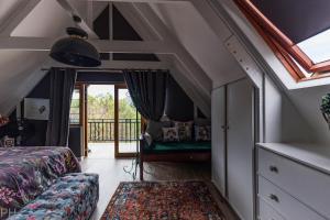a bedroom with a bed and a window at The Red Door in Clarens