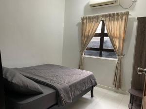 a bedroom with a bed and a window at Wans Farm House in Kuala Besut