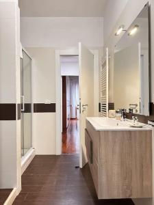 uma casa de banho com um lavatório e um espelho grande em Maison Milù di Mediterranea Host em Taranto