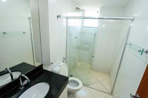 a bathroom with a shower and a toilet and a sink at Aconchego Veredas II in Viçosa