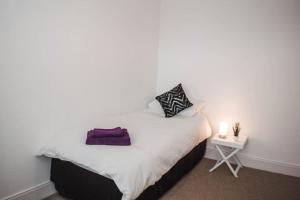 a bedroom with a bed with a small night stand at The Scot in Perth