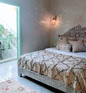 a bedroom with a bed with a large window at Riad with 3 Swimming Pools in Marrakesh