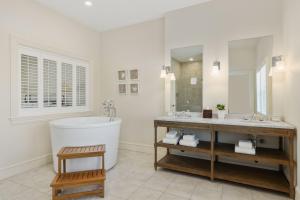 a bathroom with a large tub and a large mirror at Wychmere Beach Club in Harwich Port