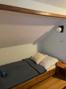 a bed with a wooden frame in a bedroom at Apartament U Joli in Tylicz