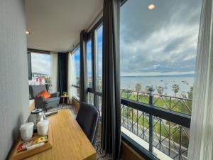 a room with a table and a view of the ocean at Mihman Hotel in Tuzla