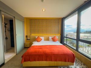 a bedroom with a large bed and a large window at Mihman Hotel in Tuzla