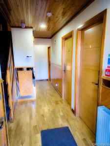a room with a hallway with wooden floors and doors at Duddingston Guest House in Edinburgh