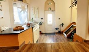 a kitchen with a sink and a counter top at Megyeház Apartman in Makó