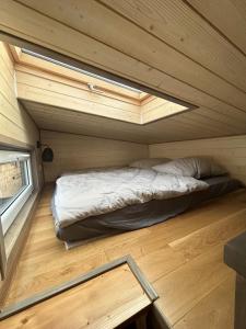 ein Bett in einem kleinen Zimmer in einem winzigen Haus in der Unterkunft Tiny House in Roxheim