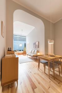 ein Wohnzimmer mit einem Tisch und einem Sofa in der Unterkunft Tripas-Coração, Santa Teresa in Porto