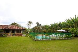 a house with a fence in front of a yard at Finca Hotel Betulia in La Tebaida