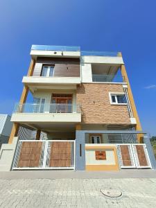 a tall building with balconies on the side of it at CasaBonito 3BHK Villa in Mysore