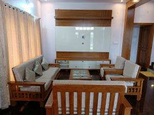 a living room with a couch and two chairs at CasaBonito 3BHK Villa in Mysore