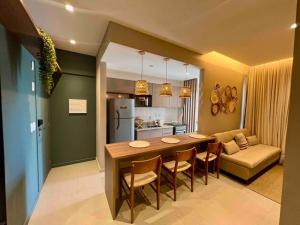 a kitchen and living room with a table and chairs at Novíssimo ,ótima localização. in Aracaju