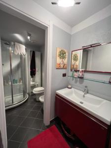 a bathroom with a tub and a sink and a toilet at Casa Agnes in Bardonecchia