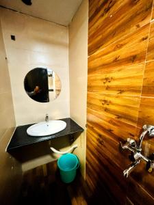 a bathroom with a sink and a mirror at Divine sparrow family homestay in Agra