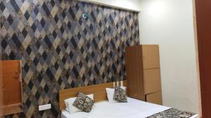 een slaapkamer met een bed en een muur bij Divine sparrow family homestay in Agra