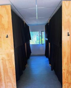 a hallway of a room with black curtains and a window at Alfar Hostel in Mar del Plata