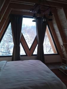 a bedroom with a bed in front of a window at Villa Tina in Štrpce