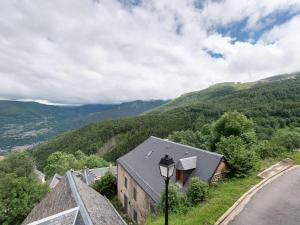 a house on the side of a hill with a street light at Chalet typique rénové à Soulan, 4 chambres, 9 pers. - FR-1-296-349 in Saint-Lary-Soulan