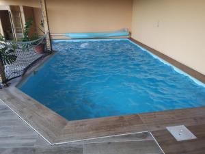 a large swimming pool in the corner of a room at Country House Zemljanka in Šentrupert