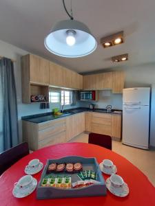 a kitchen with a red table with a red table sidx sidx sidx at Casa Estancia Vieja in Cordoba