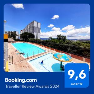 a picture of a swimming pool with a sign that says travel review awards at Mi hogar - Apartamento familiar en Bucaramanga in Bucaramanga