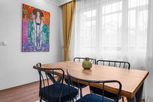 伊斯坦堡的住宿－Bright & Cozy 2BR Located In The Heart Of Living，餐桌、椅子和花瓶