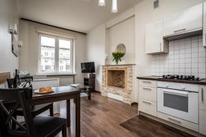a kitchen with a table and a dining room at Apartamenty Wawa Centrum by Your Freedom in Warsaw