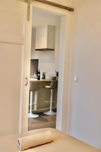 a view of a kitchen from a bedroom with a table at Anna Boutique Apartments in Nijmegen