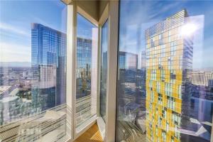 a view of a city skyline from a window at Elegant Corner 2 Bedroom Condo with Floor to Ceiling Windows in Las Vegas