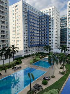 an aerial view of a large apartment building with a pool at Moa staycation in Manila