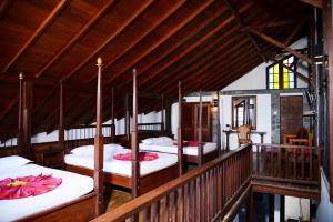 a room with four beds on a balcony at Mount Royal in Kandy