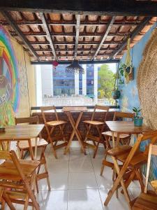 a row of tables and chairs in a restaurant at CasAMARelo Hostel in Salvador