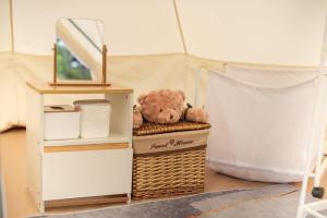 a stuffed teddy bear sitting on top of a basket at Today's Camp Khaokho ทูเดย์แคมป์เขาค้อ in Khao Kho