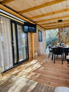 a screened in porch with a table and chairs at Mobile Home Peponi Del Mar, Soline, BRAND NEW in Biograd na Moru