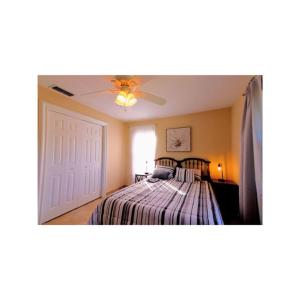 a bedroom with a bed and a ceiling fan at Cozy House in SE Cape Coral. Pet-friendly! in Cape Coral