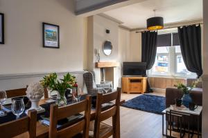 a living room with a table and a dining room at Orme Lodge in Llandudno