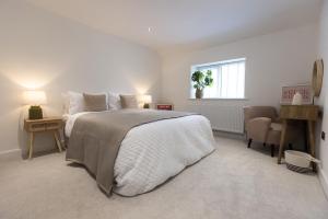 a bedroom with a large bed and a window at The Wagon Shed Stylish Conversion with Garden and Parking in Sowerby Bridge