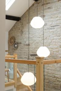 a room with three lights hanging from a brick wall at The Wagon Shed in Sowerby Bridge