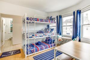 a room with bunk beds and a table at Family-Friendly Ocean City Condo Walk to Beach! in Ocean City