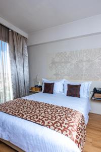 卡薩布蘭卡的住宿－肯茲西迪馬魯夫酒店，一间卧室设有一张大床和一个窗户。