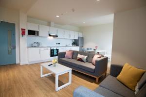 a living room with a couch and two chairs and a table at University of Galway Rooms in Galway