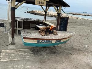 a boat on the beach with a fire in it at MALAGA BEACH, PEDREGALEJO Apt.4/6 2 Hab. in Málaga
