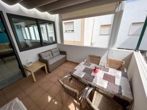 a balcony with a table and chairs and a couch at T1s Portimão - Center in Portimão