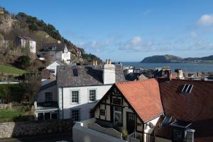 a town with houses and the ocean in the background at Orme Lodge in Llandudno